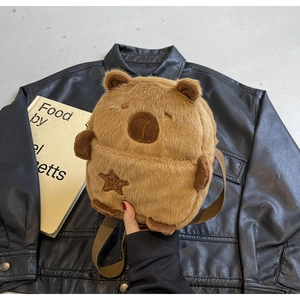 Close-up of plush Capybara crossbody bag featuring soft brown fur and star embroidery