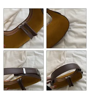 Detail view of double zippers and material splicing on retro hobo shoulder bag