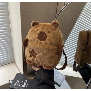 Detailed view of the soft plush Capybara bag with cute embroidery and woven strap