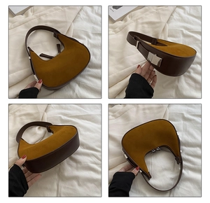 Detail view of yellow suede and brown leather hobo bag with silver metal buckles
