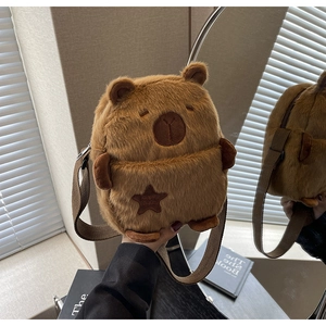 Close-up of soft brown plush bear crossbody bag with star embroidery and strap detail