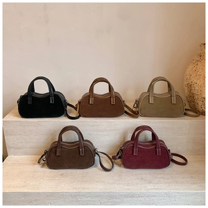 Minimalist Boston handbags in five earth-toned colors featuring suede and leather textures