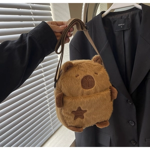 Close-up of fluffy brown Capybara plush crossbody bag with star pocket and adjustable strap