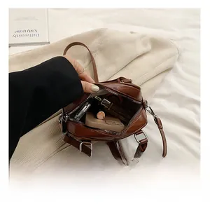 Interior view of brown faux leather bag showing spacious capacity for phone and cosmetics