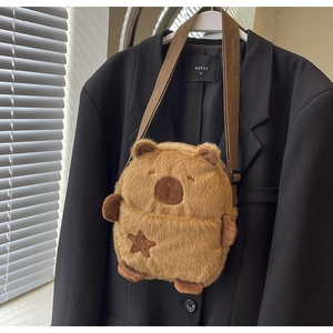 Detail of Capybara plush crossbody bag featuring star embroidery and soft furry texture