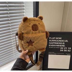 Detail of cute Capybara plush crossbody bag with soft faux fur and brown star embroidery