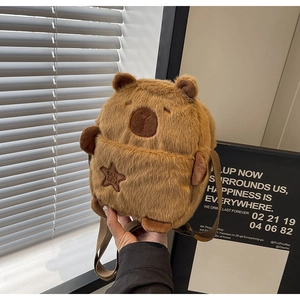 Detail of plush capybara crossbody bag featuring soft fur and star embroidery