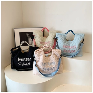Detailed embroidery and quilted pattern on lightweight multi-way tote bags in four colors