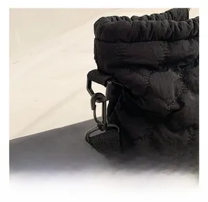 Detail of high-quality metal hook and black quilted embroidery on a lightweight tote bag