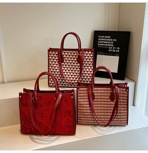 Three premium red wedding tote bags featuring houndstooth and heart patterns on steps