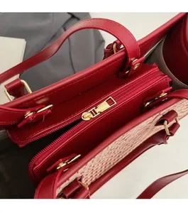 Detail of premium golden metal zipper on a red luxury bridal tote bag with weaving texture