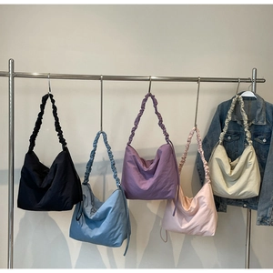 Multi-color lightweight nylon tote bags with scrunchie pleated straps on display