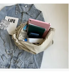 Macro view of beige nylon tote bag interior showing large capacity for tablets and bottles