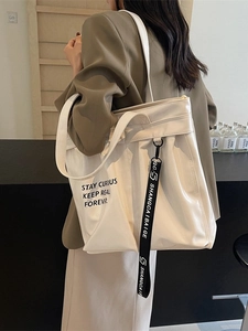 Large pearl white tote bag with black typography and logo strap for stylish daily commuting