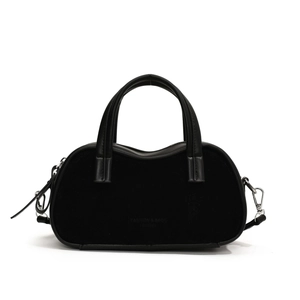 Minimalist black bowler handbag in suede texture with polished top handles and silver hardware