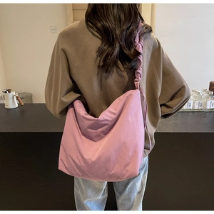 Detail of lavender nylon shoulder bag featuring a stylish ruched cloud design strap