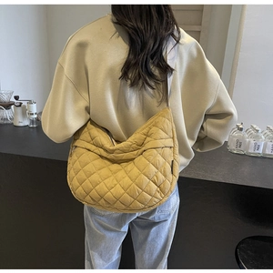 Détail du sac bandoulière matelassé jaune avec fermeture éclair argentée et sangle large