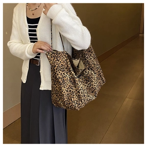 Large capacity leopard print tote bag shown in a lifestyle shoulder carry style