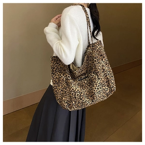 Model showing large leopard print tote bag with black shoulder strap for daily commuting