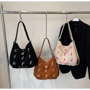 Detailed corduroy tote bags in black, brown, and off-white with letter embroidery