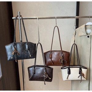 Detail showing four vintage textured tote bags in black, dark brown, caramel, and beige