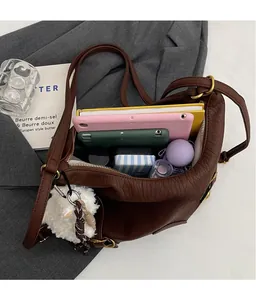 Top view of large capacity dark brown crinkled leather bag showing spacious interior items