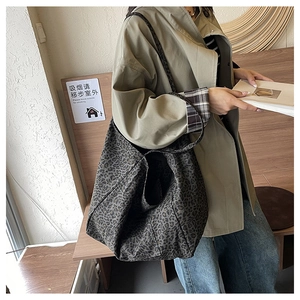 Leopard print canvas tote bag styled with a trench coat for an urban lifestyle look