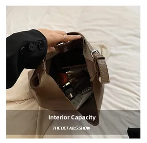 Spacious interior of brown faux leather tote bag showing lipstick and cosmetic essentials