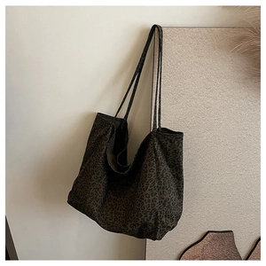 Close-up of leopard print tote bag fabric with soft texture and durable shoulder strap