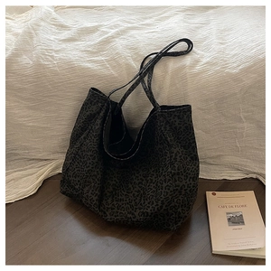Close-up of leopard print canvas tote bag with dual long handles for daily travel