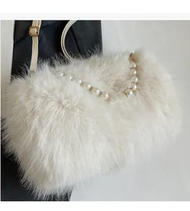 Detail of soft white faux fur texture with elegant pearl handle and gold hardware