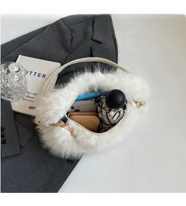 Top view of the spacious interior of a white plush faux fur bag with gold chain