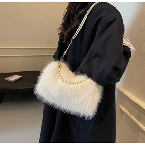 Detailed view of white faux fur handbag with pearl handle and slim leather strap