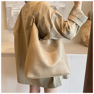 Detail of adjustable wide shoulder strap on beige minimalist hobo tote bag for women