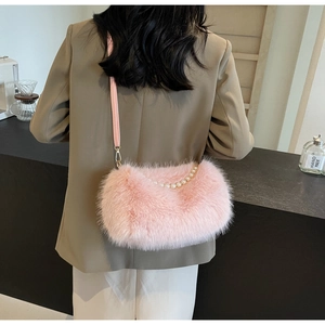 Detail of pink faux fur shoulder bag featuring elegant white pearl chain decoration