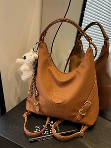 Versatile caramel leather tote bag with large capacity and cute plush bear charm