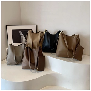 Detailed view of high-capacity tote bags in five earthy tones on a white display