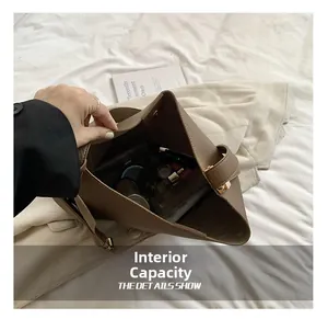 Detailed interior of large brown lychee leather tote bag showing spacious capacity