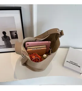 Top view of beige bucket bag showing spacious interior with tablet and daily essentials