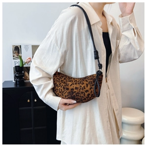 Close-up of leopard print shoulder bag with elegant pleated design and knotted strap