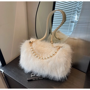 Detail of plush faux fur shoulder bag with elegant large pearl chain and leather strap