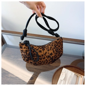 Detail of leopard print crescent bag with leather knot strap and soft velvet texture
