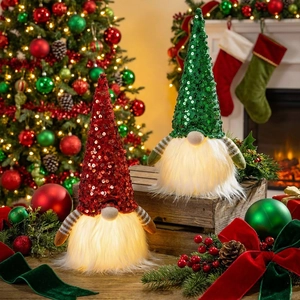 Detail of glowing Christmas gnomes with sequin hats and warm LED lights