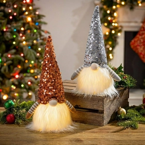 Detail of Christmas glowing gnomes with sequins hats and warm LED lights on wood