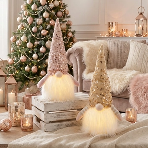 Detail of sequined hats and warm LED lights on plush Christmas gnome ornaments