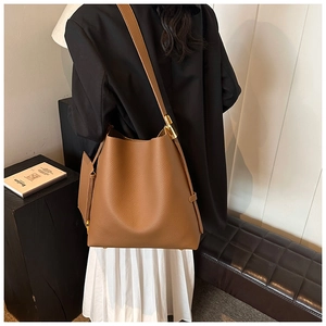 Detail of brown lychee grain tote with a matching small coin pouch and gold hardware