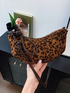 Fashionable leopard print half-moon underarm bag with decorative knotted leather strap
