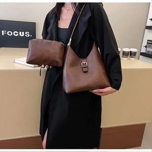 Brown leather hobo bag with patchwork texture and adjustable silver buckle detail