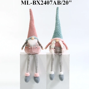 Detail of soft fabric textures on pink and teal Nordic Christmas gnome dolls with knit hats
