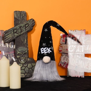 Halloween gnome with black pointed hat and gray beard in festive orange setting